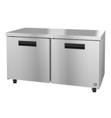 A Hoshizaki stainless steel undercounter refrigerator with two doors, black handles, and four caster wheels. The smooth, reflective surface features a flat countertop top and a small blue sticker on the bottom right corner.
