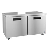 A Hoshizaki stainless steel undercounter refrigerator with two front doors, black handles, and four wheels. Its flat top surface is ideal for kitchen prep work, and a small blue logo accents the lower right corner.