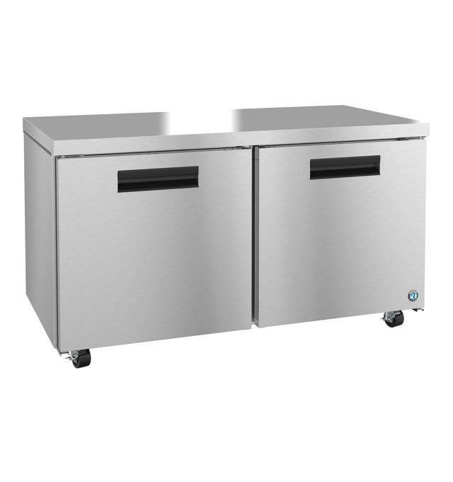 A Hoshizaki stainless steel undercounter refrigerator with two front doors, black handles, and four wheels. Its flat top surface is ideal for kitchen prep work, and a small blue logo accents the lower right corner.