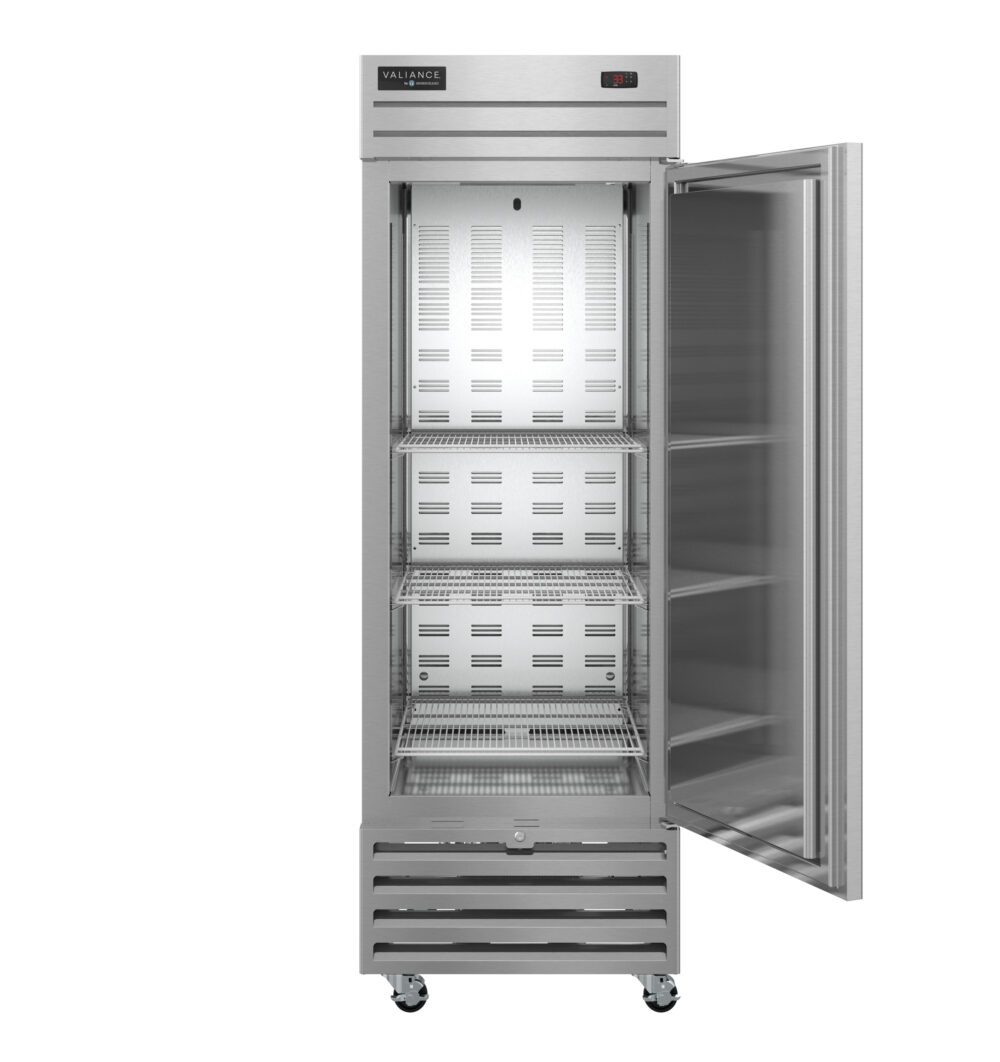 A Valiance Series Refrigerator stands upright with its glass door open, revealing three metal shelves inside. This ENERGY STAR refrigerator features wheels, ventilation grilles at the bottom, and a digital temperature display on the top right.