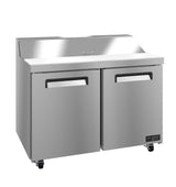A Valiance Series stainless steel sandwich prep refrigerator with two doors, a flat work surface, raised rear edge, and black handles. The unit sits on four wheels, with the VALIANCE label visible on the lower right corner.