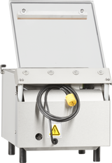 A Berkel 250-STD Vacuum Packaging Machine with a single stainless steel chamber stands on four black legs. Its open top lid reveals the interior, while a thick black power cord with a yellow plug hangs over the front and a high-voltage warning sticker is displayed.