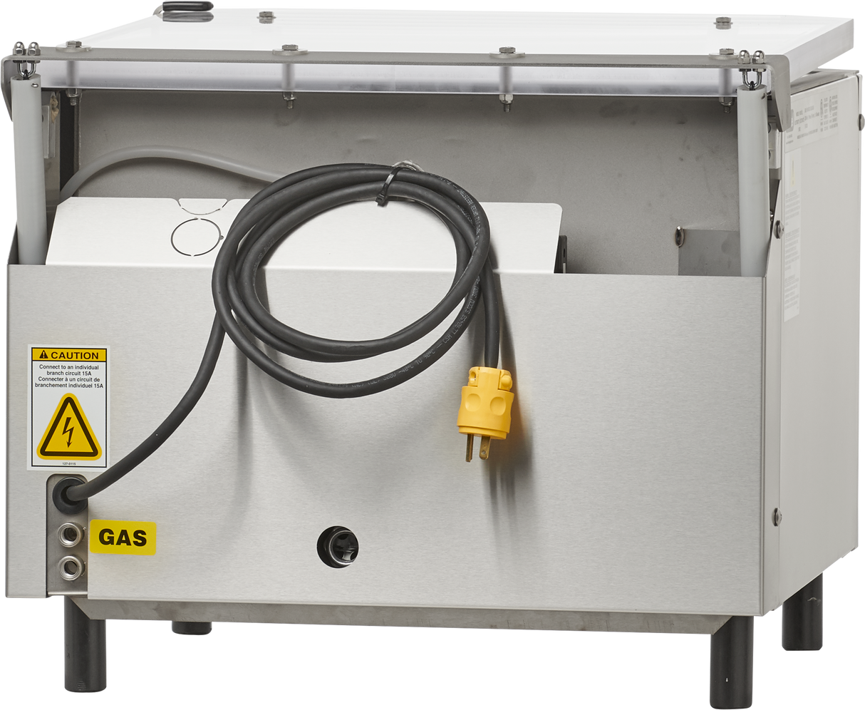 A stainless steel Berkel single chamber Vacuum Packaging Machine features an open front panel revealing internal components, a black hose, and a yellow electric plug. Warning and gas stickers are visible on the front, with small legs and a transparent top cover.