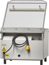 A Berkel stainless steel single chamber Vacuum Packaging Machine with a hinged lid opens upward, exposing a coiled black power cord with a yellow plug. Labels indicate “CAUTION” for electrical risk and “GAS.” The appliance stands on four black legs.