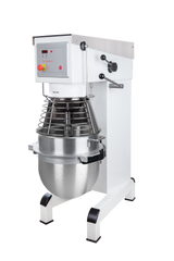 A commercial planetary mixer with a large stainless steel mixing bowl, metal wire guard, digital control panel, two control knobs, and a sturdy white frame with black-tipped feet, photographed against a plain white background.