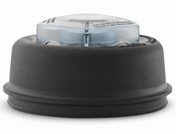A close-up image of a black and clear blender blade assembly. The base is round, made of thermoplastic rubber with a slightly flared bottom edge. It’s designed for 64 oz standard containers with a clear top section and embossed safety warnings.
