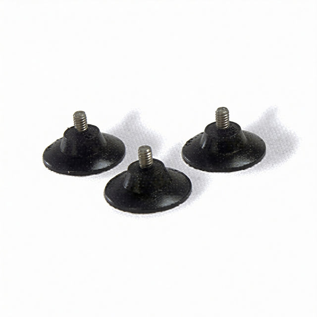 Three small, round black rubber suction cup feet with threaded metal studs are arranged on a white surface. The studs protrude from each foot’s center, designed for screwing into equipment for added stability or vibration reduction.