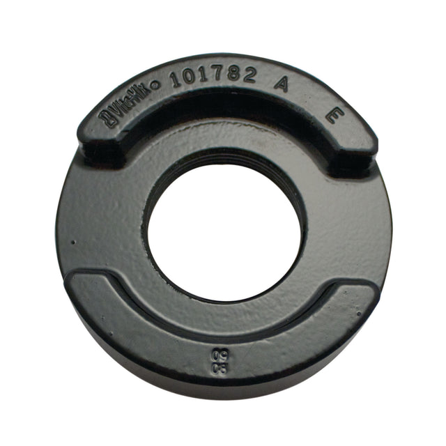 A black, round metal counterweight with a central hole and raised edges, often used as a Vitamix replacement part for the 64 oz XL container. Features embossed text “101782,” “A,” “E,” and “50” on its smooth, shiny surface.