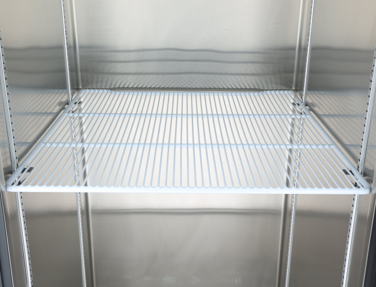 An empty Atosa USA MBF8001GR refrigerator shelf with white metal bars, set inside a clean, metallic fridge interior. The additional shelf spans the width of the fridge, creating a stark and minimal appearance with no items or decorations present.