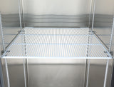 An empty Atosa USA MBF8001GR refrigerator shelf with white metal bars, set inside a clean, metallic fridge interior. The additional shelf spans the width of the fridge, creating a stark and minimal appearance with no items or decorations present.