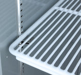 Close-up of an empty white wire shelf inside a refrigerator or storage unit, possibly an Atosa USA model. The metal rack is supported by adjustable brackets and shelf clips on a grooved vertical rail, allowing height customization. Background is smooth, light gray.