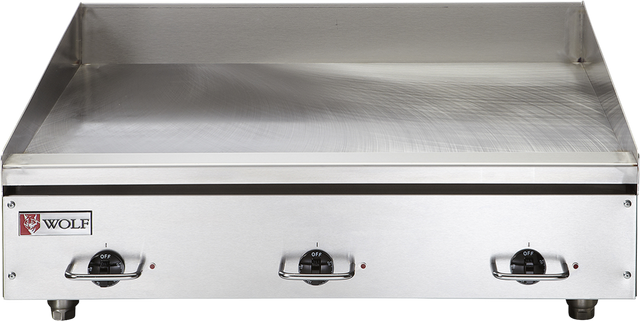 A heavy duty electric griddle, the Wolf WEG48E_208/60/3 features a stainless steel finish, three black control knobs, and the Wolf logo on the bottom left. Its reflective surface is bordered by a tall backsplash, raised edges, and sturdy short black feet.