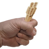A hand is holding three bamboo meat marker picks with the words GLUTEN FREE engraved on each stick, isolated on a white background.