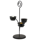 A black powder coated metal stand with a spiral top, inspired by the Cascade Tasting Flight, holds three small black bowls at varying heights. Perfect as a wine glass holder or for serving condiments in an elegant, minimalist style.
