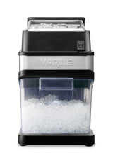 A stainless steel and black Waring Ice Crusher machine is shown. Crushed ice fills the clear lower container, while whole ice is visible in the upper compartment. The Commercial Ice Crusher sits on a black base against a white background.