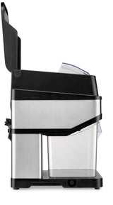 A stainless steel and black countertop ice crusher shown from the side, likely an electric model. It has a clear plastic bin at the bottom, a cord wrapped on the back, and a hinged black lid open at the top.