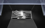 Close-up of an industrial Ice Crusher’s blades, seen from above. Multiple sharp, interlocking, jagged metal teeth are visible inside a black and silver encasement, with a partially transparent plastic lid at the top of the image.