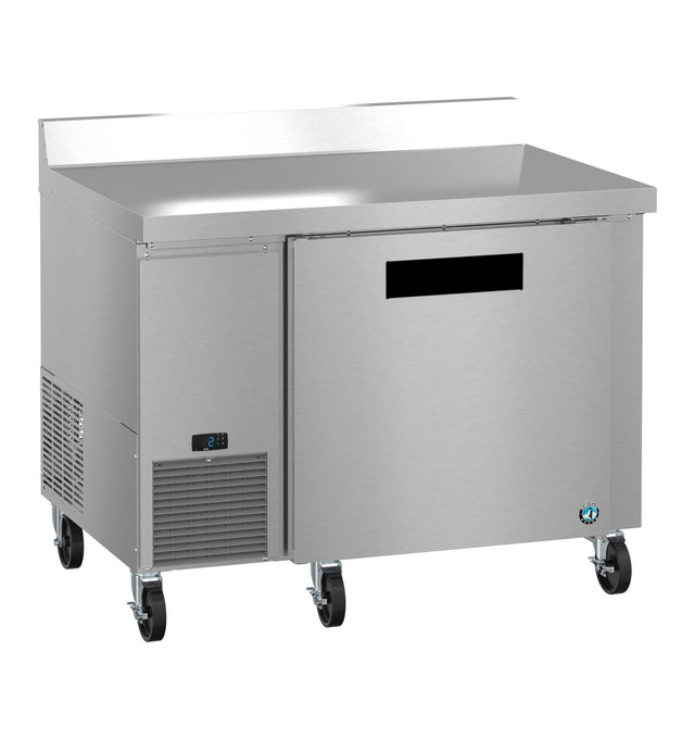 A stainless steel worktop freezer on four caster wheels with a single solid door, a digital control panel on the lower left, and a raised back edge. This ENERGY STAR unit boasts a sleek, modern look and is isolated on a white background.