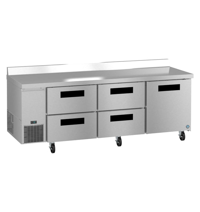 A large stainless steel three-section worktop refrigerator with four drawers and two doors. The unit is on wheels, features a vented section on the left for cooling, a raised back edge, and a flat, smooth surface ideal for food preparation.