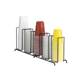 A black metal wire rack cup organizer holds four stacks of disposable cups: white on the left, clear and red in the middle, and yellow on the right. The rack is placed on a white background.