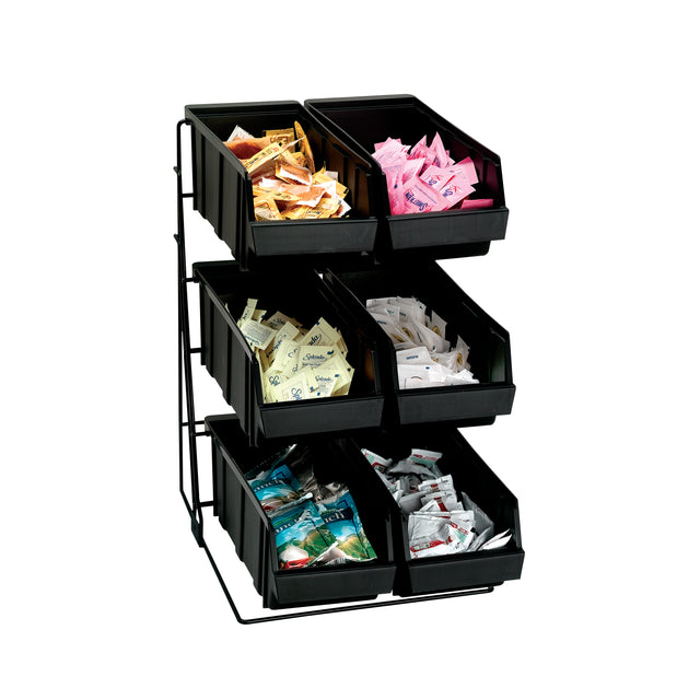 A six-compartment packeted condiment organizer holds various sweeteners, creamers, and condiments in removable plastic bins, each grouped separately. The rack has three rows with two bins per level, all set against a plain white background.
