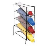 A black adjustable wire rack holds four stacks of disposable plastic cups in angled slots. The cups are white, blue, red, and yellow, with some featuring stripes. This upright cup dispenser keeps the stacks neatly organized.