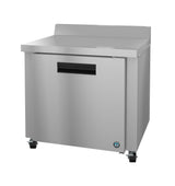 A Hoshizaki Steelheart worktop refrigerator with stainless steel construction, a flat top, single door with black handle, four caster wheels, a small logo on the lower right corner, and a raised rear edge for added utility.