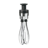 A metal rotary hand whisk with two looped stainless steel beaters, a cylindrical black handle, and a silver band near the top. The handle has a plunger for manual operation. Resembles the Waring Big Stix Whisk Attachment, upright on white background.