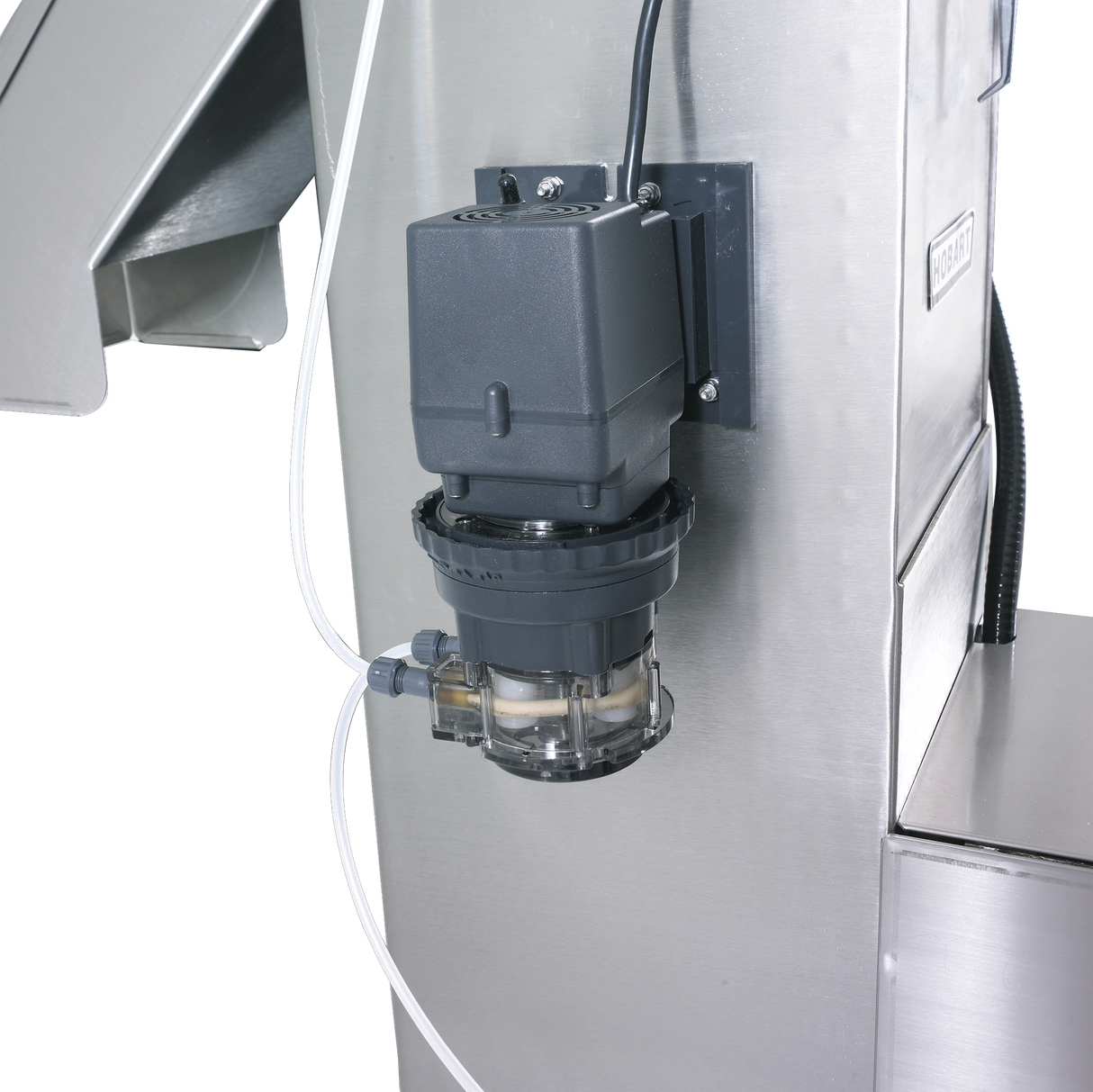 A close-up of industrial equipment shows a black motor attached to a stainless steel structure, part of the Hobart WPS1260. Clear tubing connects to a transparent chamber below the motor, revealing internal components against a black background.