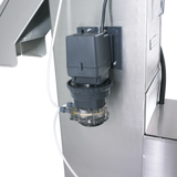 A close-up of industrial equipment shows a black motor attached to a stainless steel structure, part of the Hobart WPS1260. Clear tubing connects to a transparent chamber below the motor, revealing internal components against a black background.