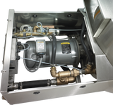 A close-up view of industrial machinery inside a stainless steel enclosure, featuring a cylindrical motor, brass valves, hoses, and wiring—part of a Hobart WastePro self-contained pulper with a motorized drain valve in an organized layout.