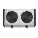 A stainless steel double electric hot plate features two heavy-duty cast iron burner plates, each with a control knob and indicator lights below. The unit has black side handles and a minimalist design, shown on a plain white background.