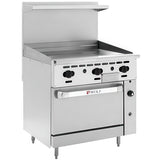 A stainless steel commercial restaurant range with a thermostatic griddle on top, six black control knobs, a large oven door labeled “Wolf,” and a backsplash with a small shelf above. The range stands on four adjustable legs.