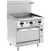 A stainless steel commercial restaurant range with a thermostatic griddle on top, six black control knobs, a large oven door labeled “Wolf,” and a backsplash with a small shelf above. The range stands on four adjustable legs.