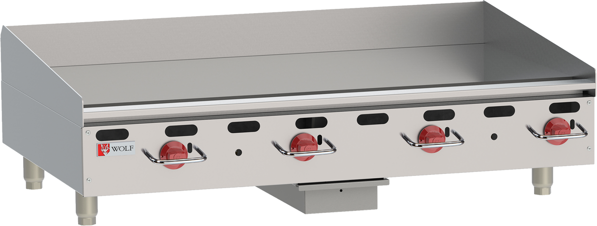 A heavy duty countertop gas griddle with four red control knobs, a flat cooking surface, raised back and side splashes, short metal legs, and the Wolf brand logo displayed on the left of the stainless steel front panel.