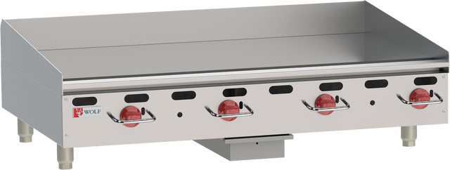 A heavy duty countertop gas griddle with four red control knobs, a flat cooking surface, raised back and side splashes, short metal legs, and the Wolf brand logo displayed on the left of the stainless steel front panel.