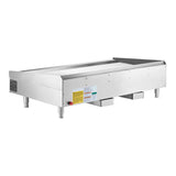 The Wolf AGM60_NAT is a heavy duty commercial gas griddle with four short legs, a flat cooking surface, control knobs, and safety labels. Elevated for countertop use, it features a front grease trough—ideal for any professional kitchen.