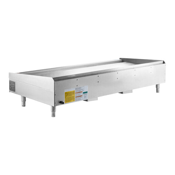 The Wolf AGM72_NAT is a heavy duty gas griddle featuring a stainless steel build with four short legs, a flat heating surface, and raised edges. Control knobs and safety labels are visible, designed for countertop use in commercial food service settings.