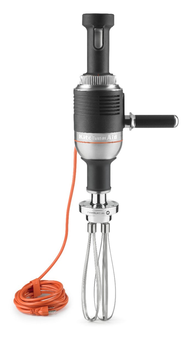 A black KitchenAid Commercial Immersion Blender with a side handle, metallic whisk attachment, and an orange power cord coiled neatly at the base. The heavy duty immersion blender is displayed upright against a white background.