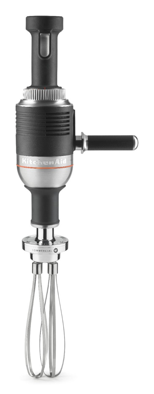 A black and silver KitchenAid Commercial Immersion Blender features a 12 inch stainless steel blending arm, two metal whisk attachments, an ergonomic handle, and top grip for control. The sturdy, industrial design displays the brand name clearly on the body.