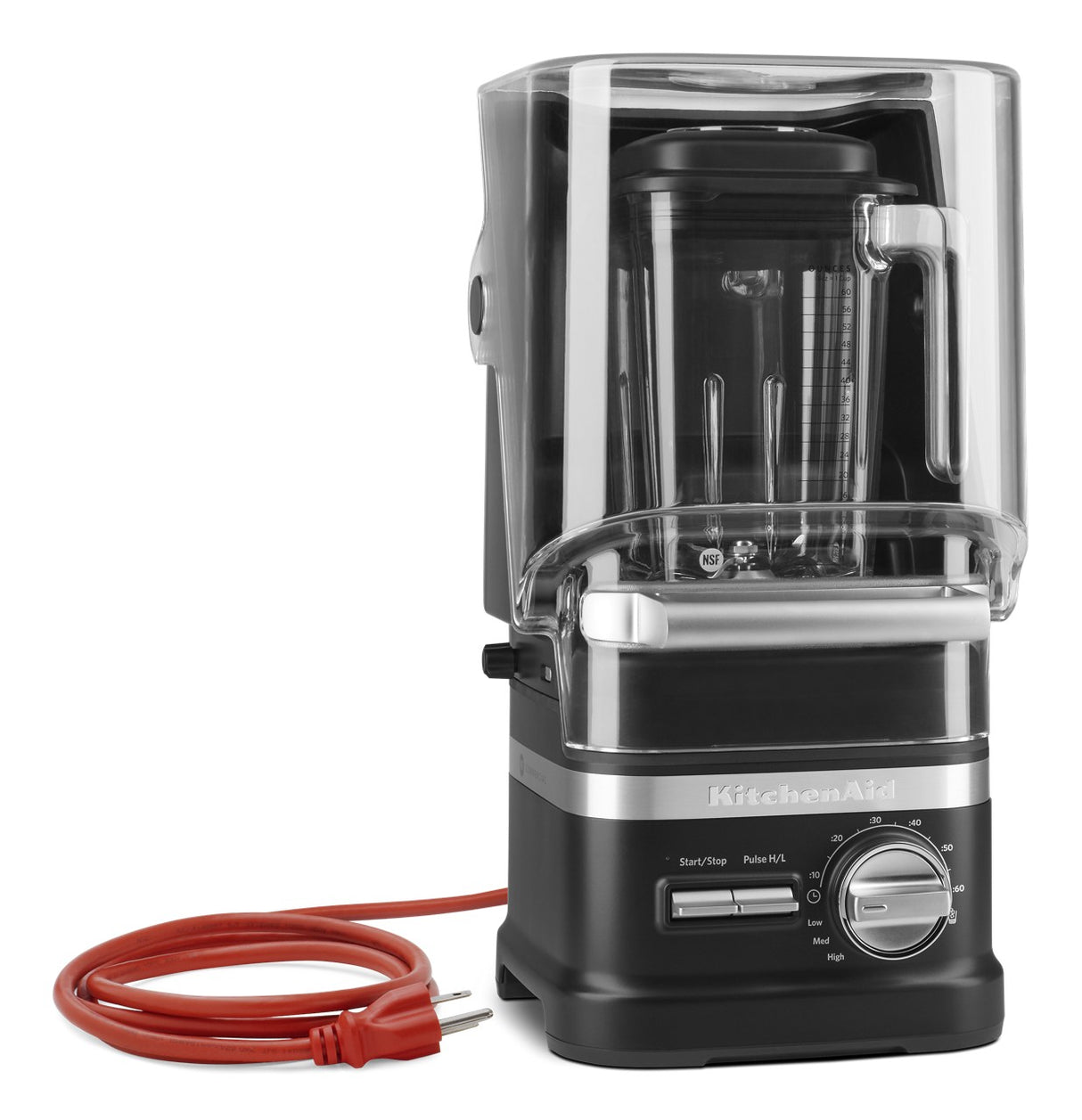 A black and silver KitchenAid Commercial Blender with a clear noise-reducing enclosure, control dial, buttons, and a red power cord coiled beside it sits against a white background—a sleek 60 oz blender for any kitchen.