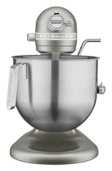 A metallic silver KitchenAid Commercial Stand Mixer with an 8 quart bowl and a sturdy handle. The mixer head bears the KitchenAid logo, while a metal mixing attachment sits inside the spacious stainless steel bowl.