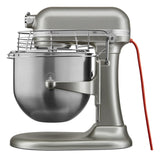 A silver KitchenAid Commercial Stand Mixer with a large 8 quart bowl and a safety guard on top. The mixer features a modern design, sleek red power cord, and sturdy base—perfect for handling big batches with ease.