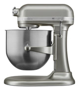 A metallic silver KitchenAid Commercial Stand Mixer with an 8 quart bowl and smooth, rounded design is shown from the side. The mixer features a lever for raising the large stainless steel bowl and visible KitchenAid and Commercial labels on top.