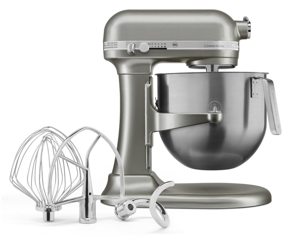A sleek, modern KitchenAid Commercial Stand Mixer with a stainless steel 8 quart bowl. In front are three metal attachments—a wire whisk, flat beater, and dough hook—each crafted for versatile mixing tasks using advanced PowerCore technology.