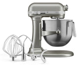 A sleek, modern KitchenAid Commercial Stand Mixer with a stainless steel 8 quart bowl. In front are three metal attachments—a wire whisk, flat beater, and dough hook—each crafted for versatile mixing tasks using advanced PowerCore technology.