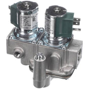 A close-up view of a dual solenoid gas valve assembly with metallic housing, two green solenoid coils, electrical terminals, and pipe fittings—typically used for controlling gas flow in heating systems or Groen steamer applications.