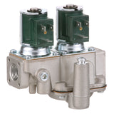 A close-up of a dual solenoid gas valve with two green solenoid coils mounted on top, threaded ports on the sides, and various screws and components on a rectangular metal housing, commonly used in Groen Steamer systems.