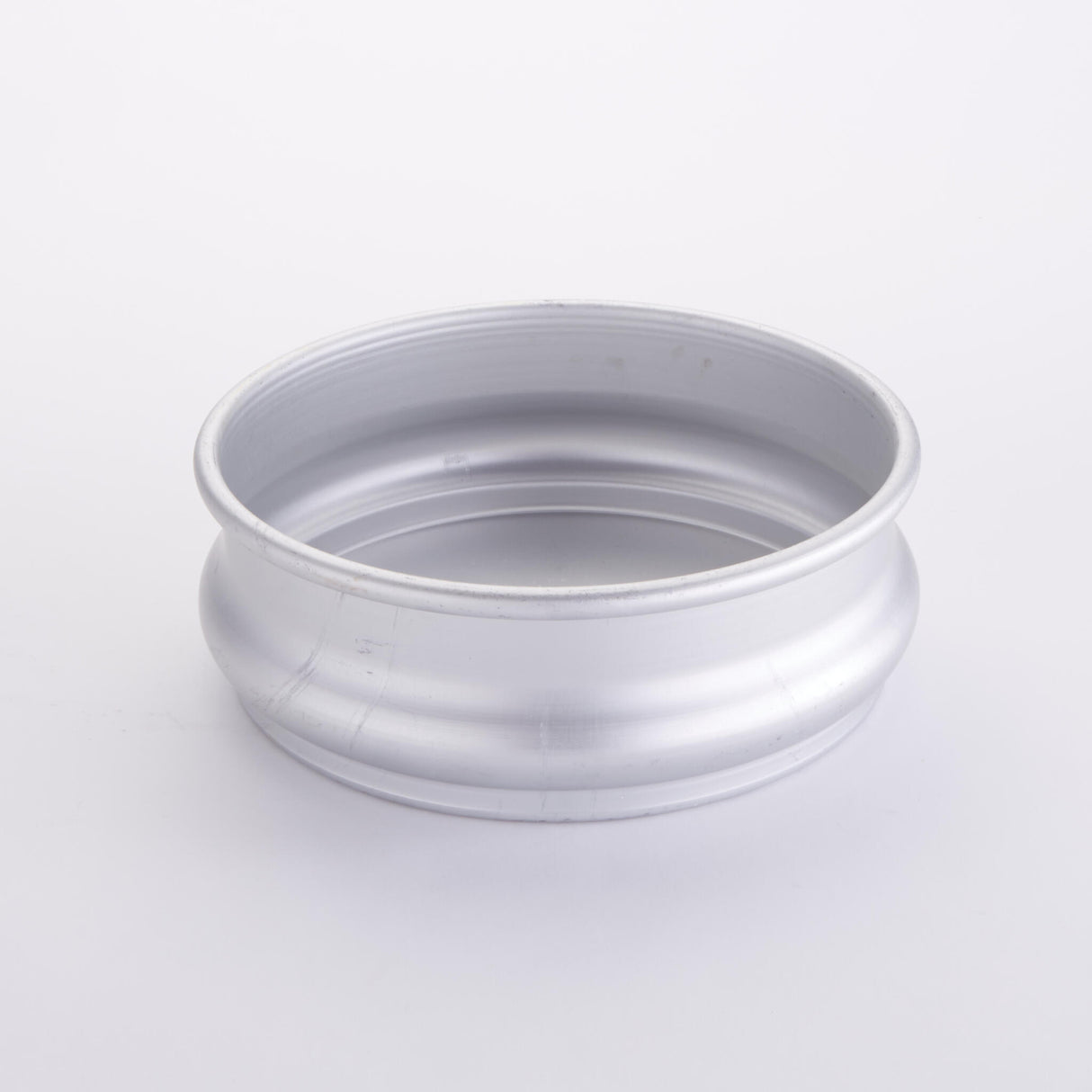 A silver metal circular rim, part of the American Metalcraft Dough Retarding Proofing Pan, is shown against a plain white background. The rim has a smooth, slightly curved surface with a raised outer edge and appears clean and unused, resembling the component of a high-quality 96 oz aluminum pan.