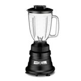 A countertop bar blender with a clear copolyester container, black lid, visible stainless steel blades, and a sturdy black base featuring a silver control panel and dial; the jar has a handle and measurement markings. The background is plain white.
